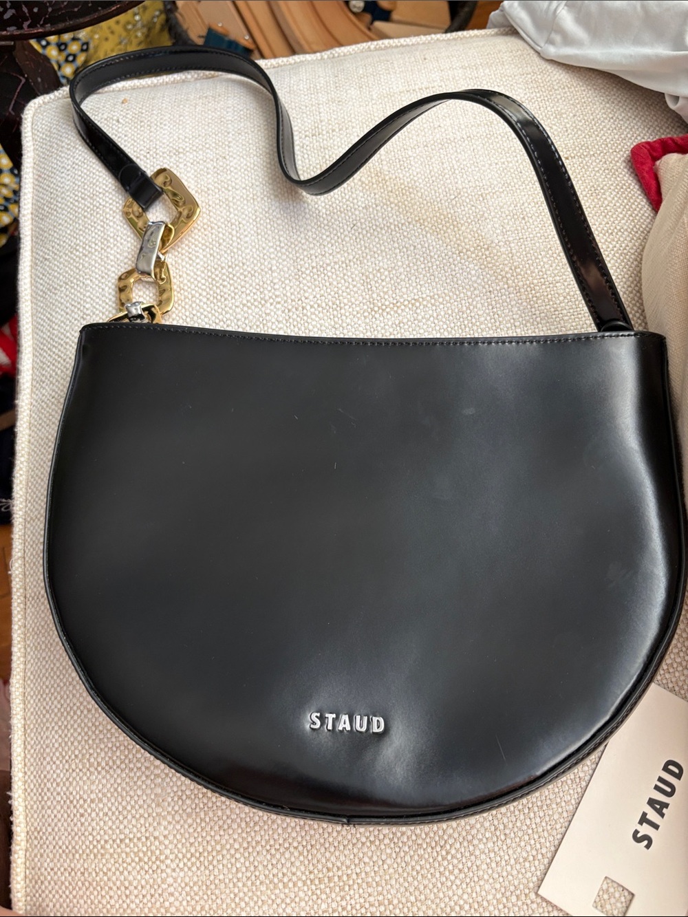 STAUD Black Half Moon Leather Shoulder Bag with Gold Chain Accent